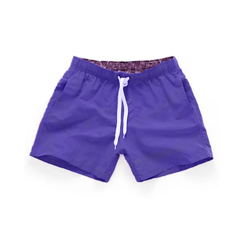 Men's polyester beach shorts with straight leg opening in multiple colours including black, white, and fluorescent yellow
