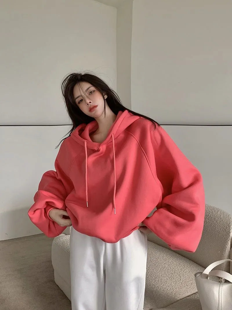 Watermelon red women's sleeveless Mulberry Silk hoodie on a hanger.