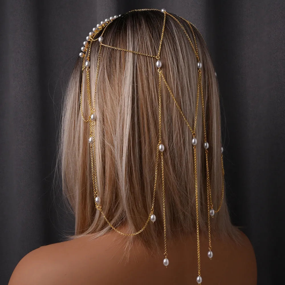 Close-up of a gold mesh hair chain with pearls and a tassel detail for women.