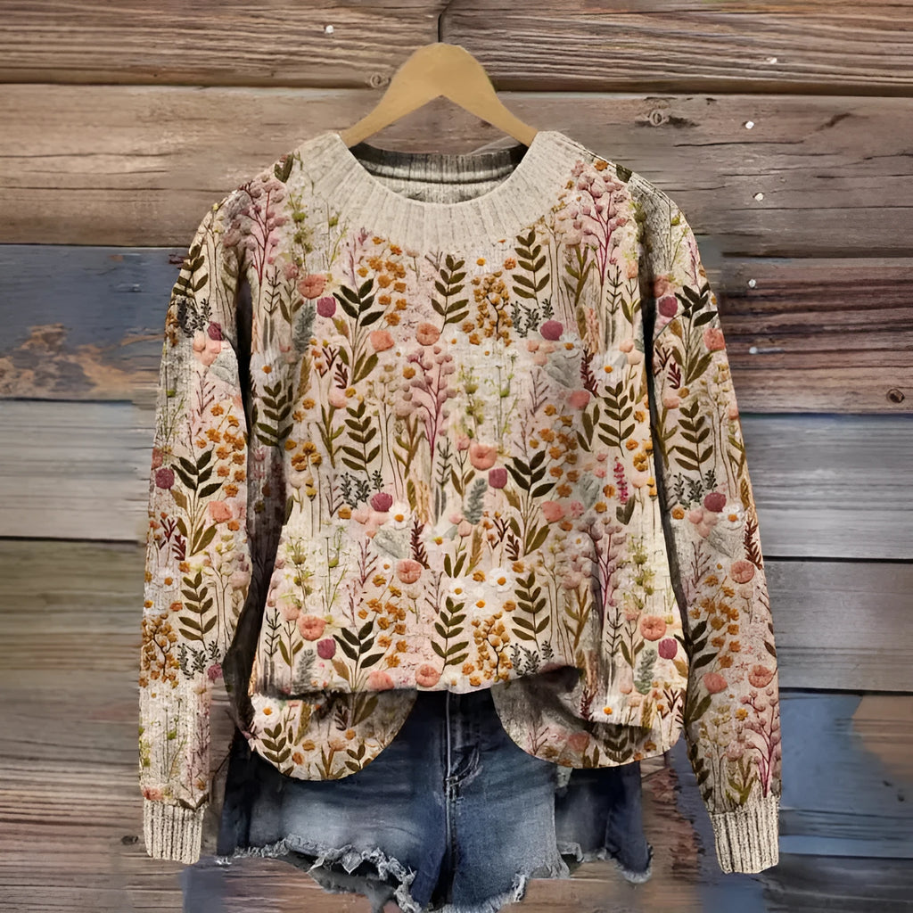 Women's lilac floral printed round neck sweater on a hanger showing the knitted texture.