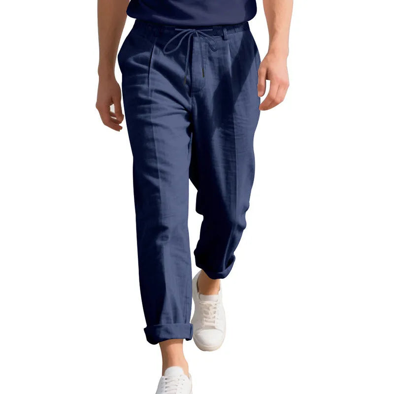Men's loose-fit straight-leg linen trousers in light khaki colour with a drawstring waist.