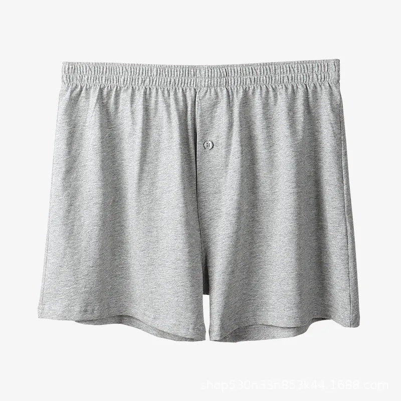 Men's solid-colour pure cotton boxer shorts with a high-waist and loose fit on a plain background.