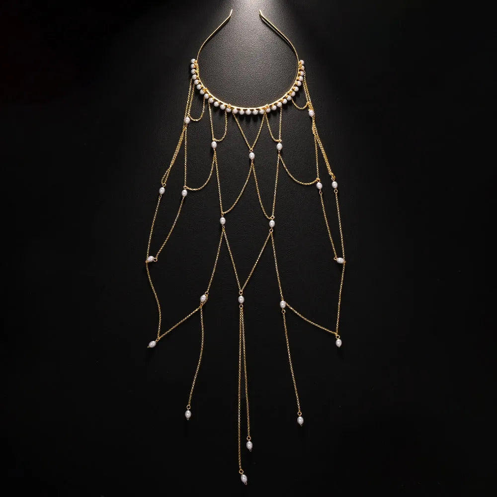 Close-up of a gold mesh hair chain with pearls and a tassel detail for women.