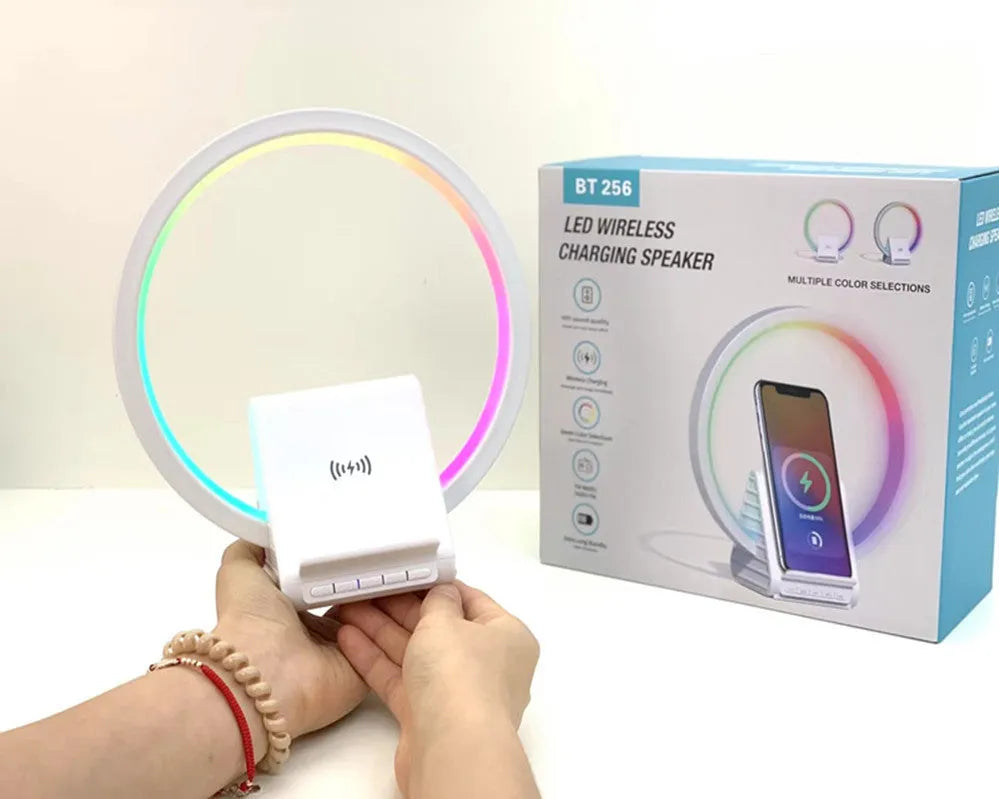 White square Bluetooth speaker with integrated wireless charging pad and ambient LED lighting.