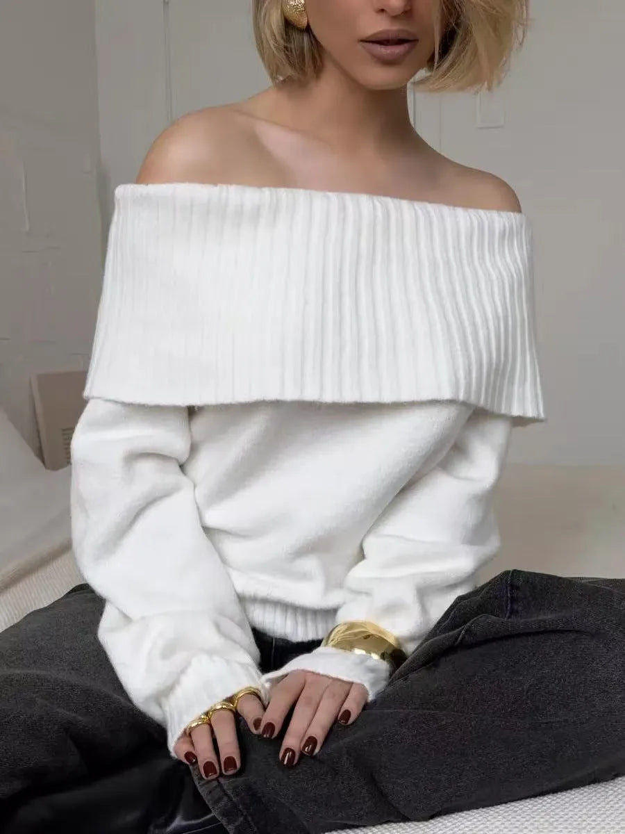 Woman wearing a grey off-the-shoulder strapless sweater with a 3D textured pattern.