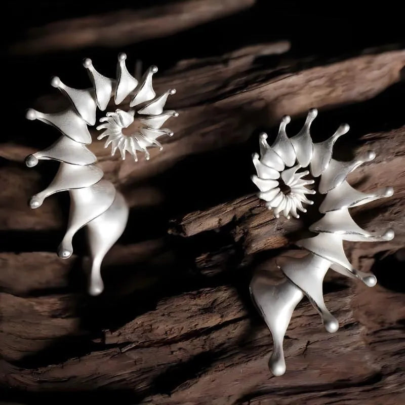 Conch ear studs with exaggerated three-dimensional matte finish and irregular geometric shape