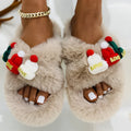 Women's black Christmas slippers with Santa hat decoration on plush faux fur upper.