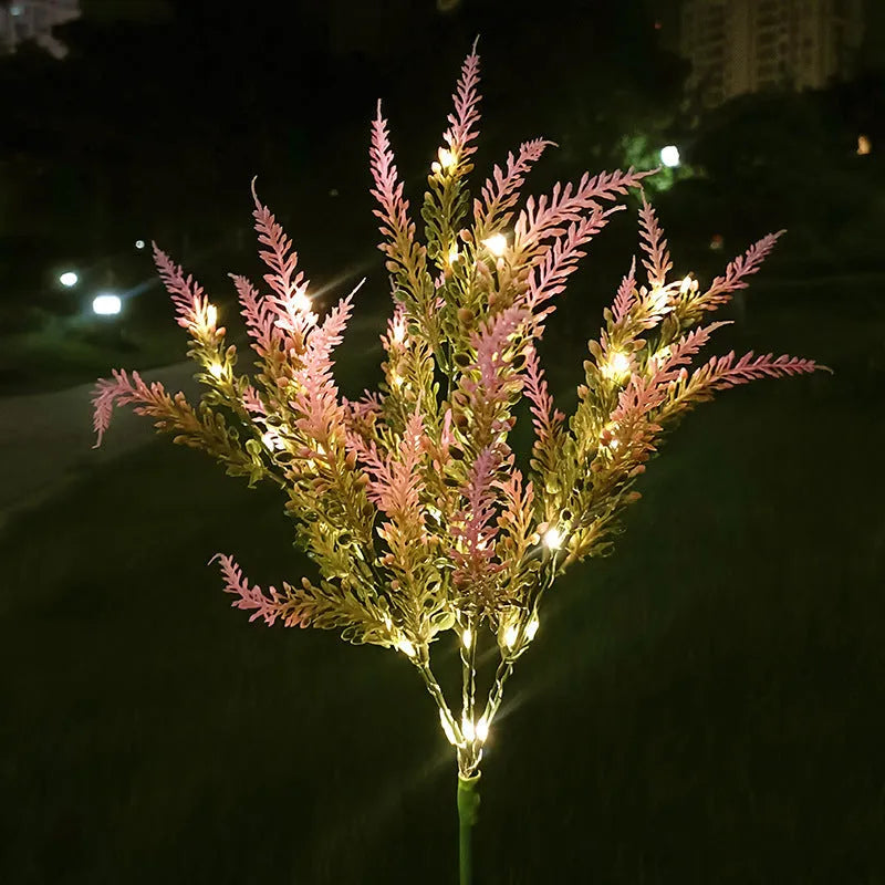 A pink flower-shaped solar LED garden light standing 74 cm tall in an outdoor setting.