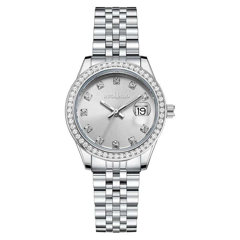 Women's silver alloy fashion watch with circular dial and stainless steel buckle on wrist.