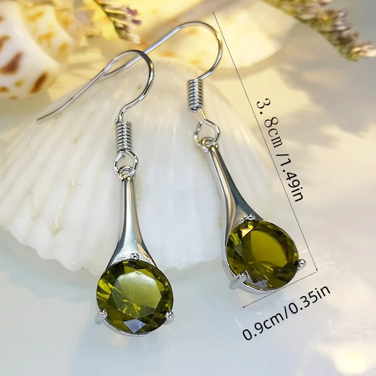 Olive green topaz coloured drop earrings with a water drop shape and minimalist retro design.