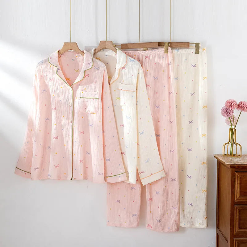 Women's thin cotton long-sleeved pajama set in pink, showing top and trousers laid flat.