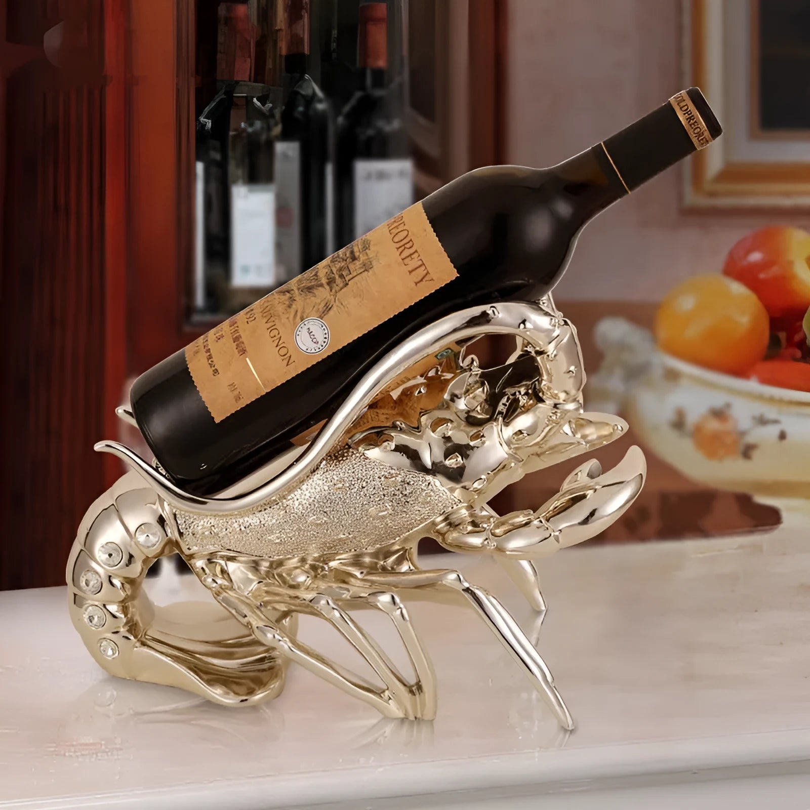 Rose gold resin lobster ornament holding a wine bottle on a wooden shelf.