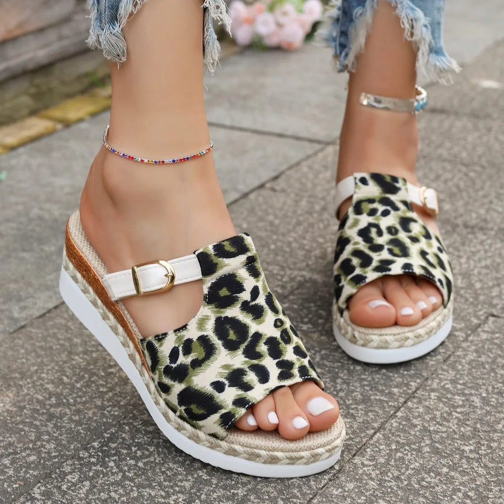 Leopard print wedge platform sandals with a fish mouth toe on a rubber sole.