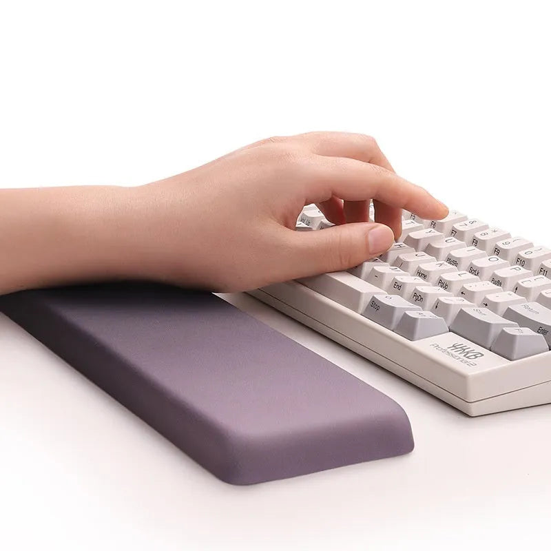 Square black silica gel wrist rest mouse pad on a desk with keyboard
