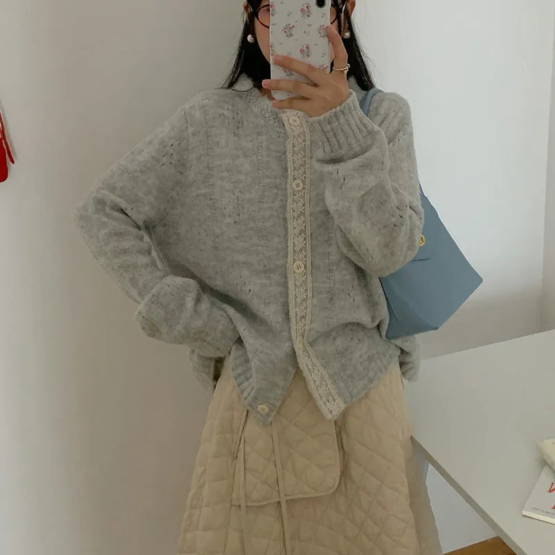 Loose apricot-coloured retro-style knit cardigan coat on a hanger