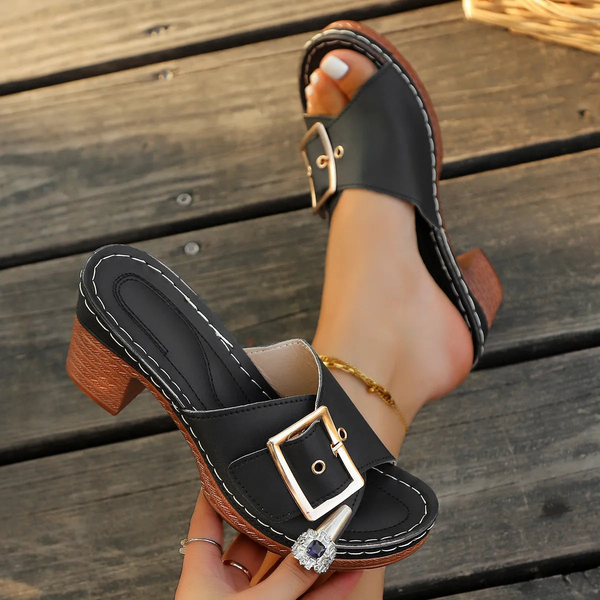 Women's black chunky heel slippers with metal buckle detail and round toe