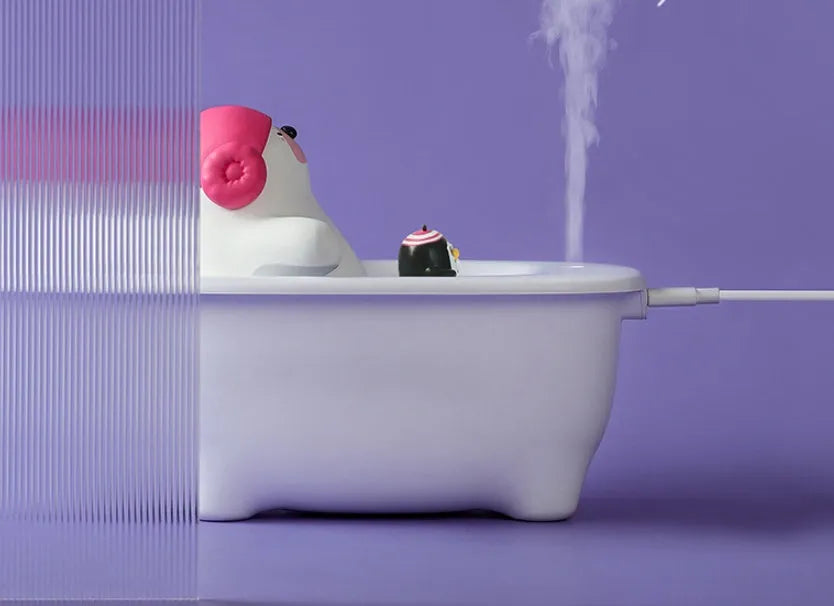 White Creative Air Humidifier with USB cable on a desk, showing its compact size and large water tank.