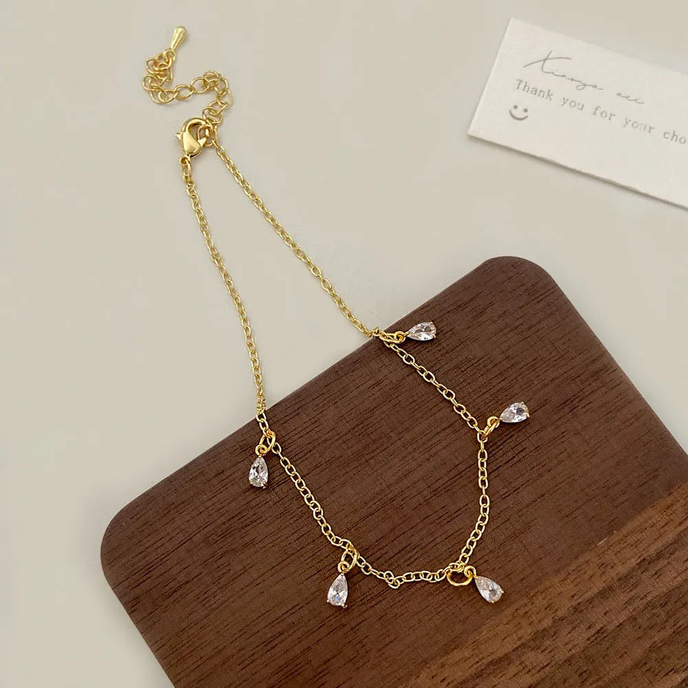 Women's zircon jewellery set with geometric necklace, earrings and anklet in meteor shower design