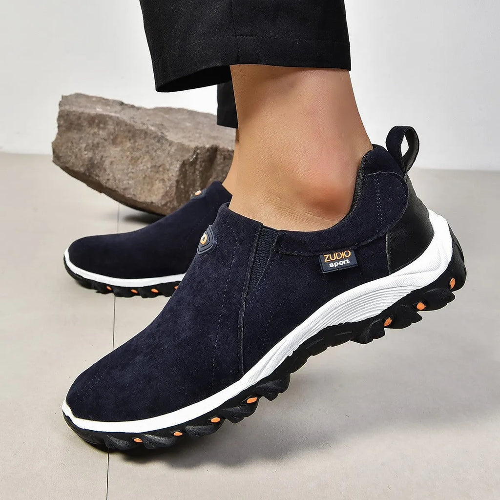 Men's thin slip-on overshoe covers in grey, blue, light brown, green, and black colours on a rubber sole.