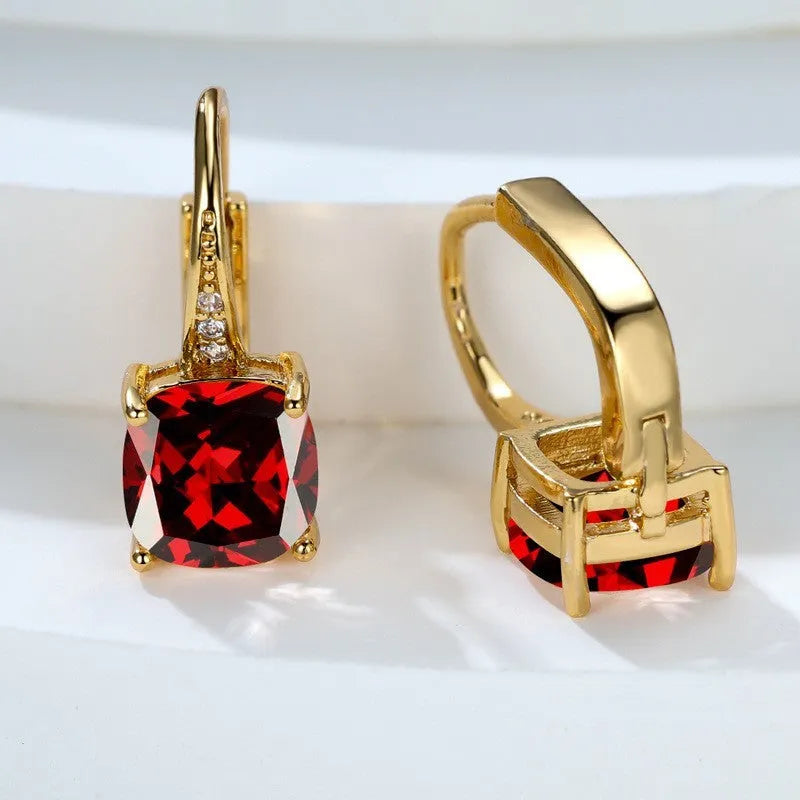 Square geometric ear hook earrings with zircon stones in an electroplated copper setting.