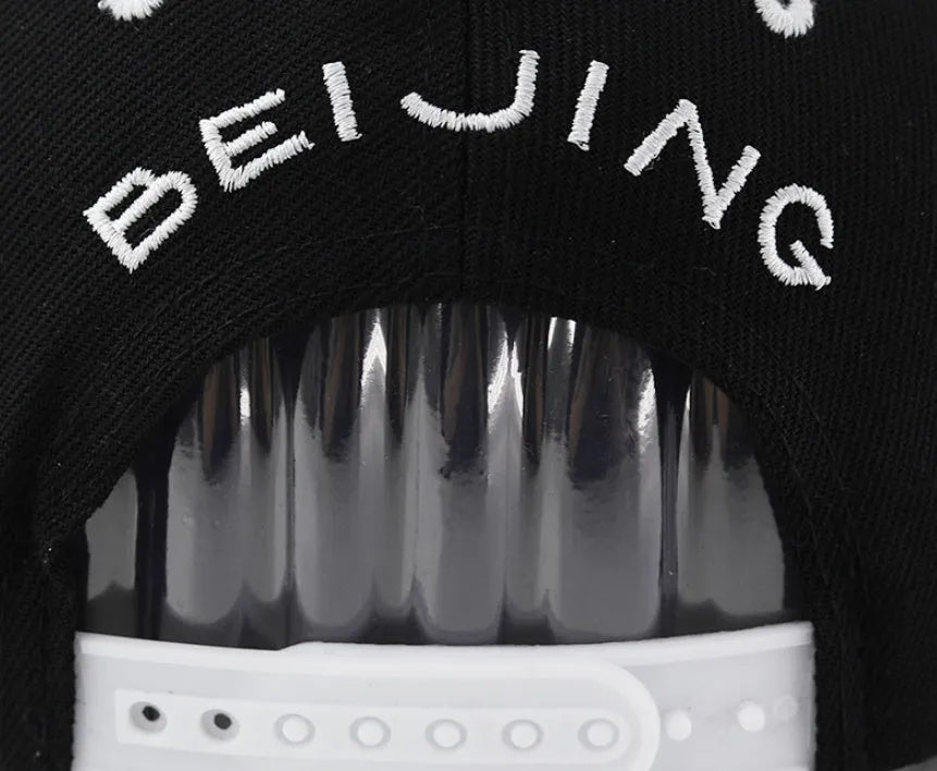 Embroidered letter baseball hat in cotton with adjustable strap, dome crown, black and white colour options