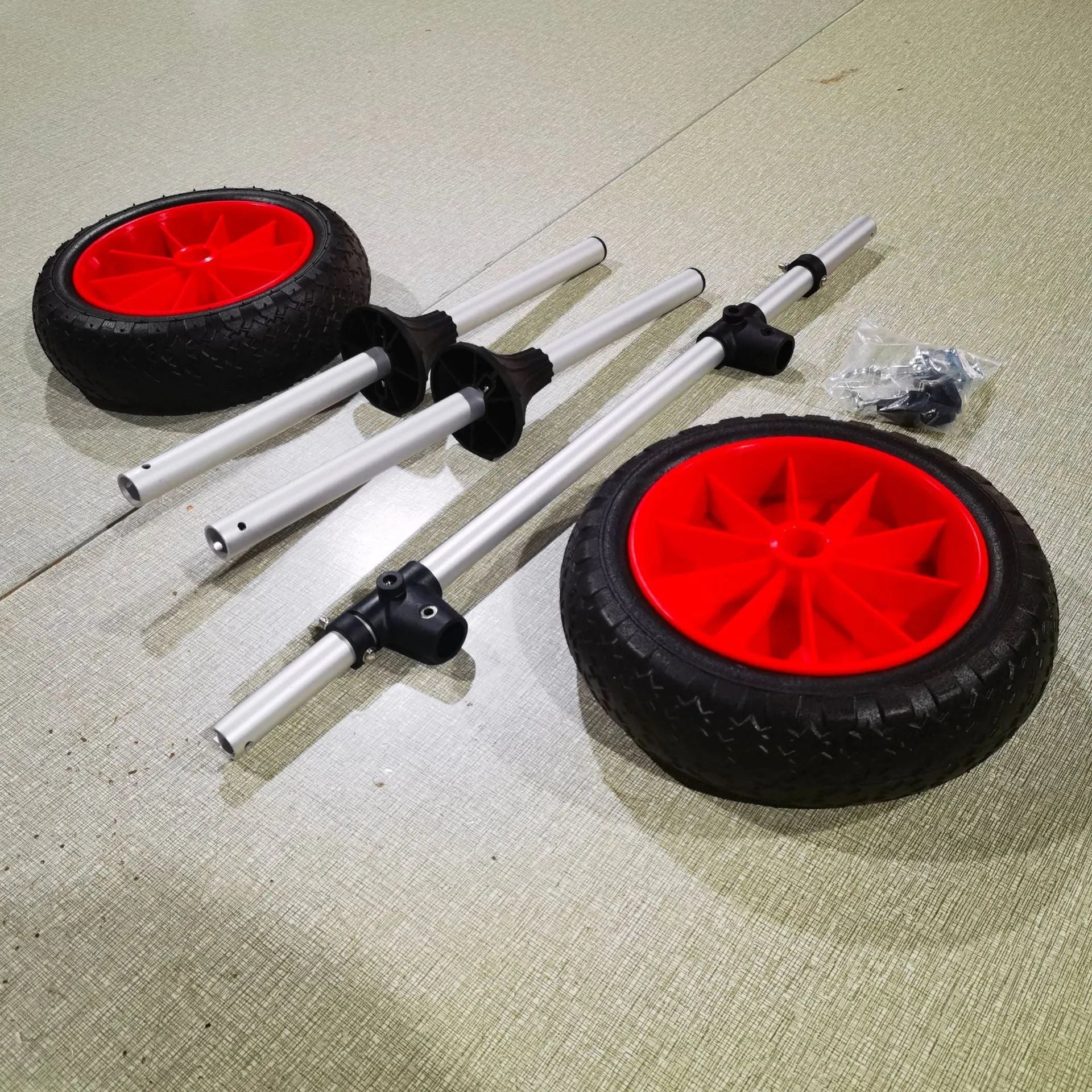 Foldable kayak beach trailer cart with upright pole, made from silver aluminium alloy tubing and black rubber.