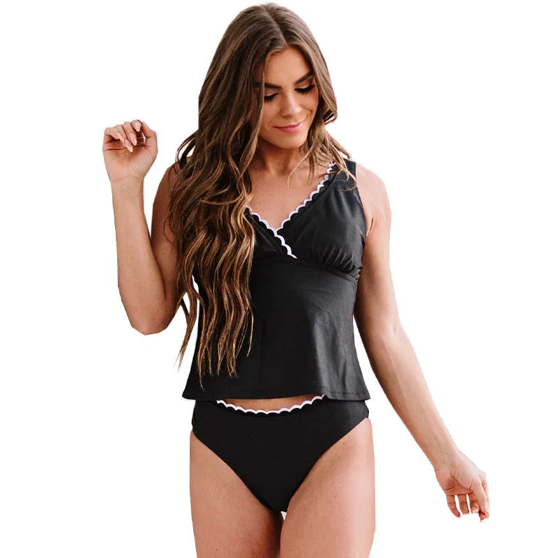 Black one-piece sleeveless swimsuit for women on a mannequin, showing the solid colour and split design.