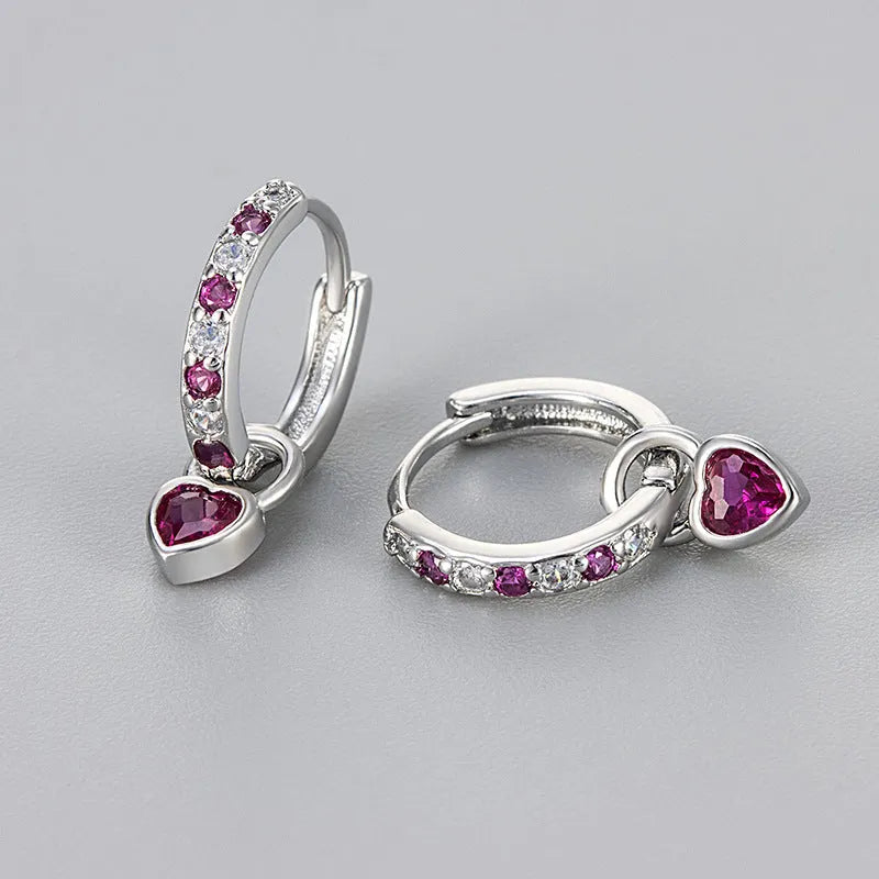 Women's heart-shaped ear clips with a coloured stone, available in gold or white gold colour.