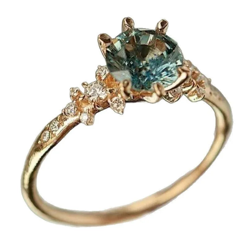 Gold geometric ring with claw setting and inlaid zircon element on alloy band