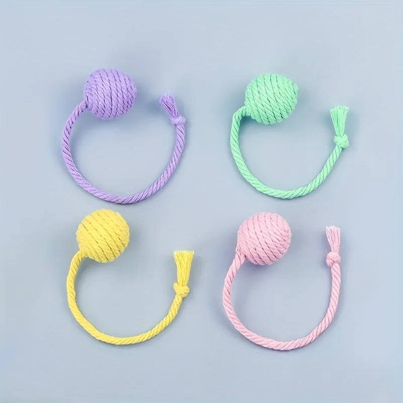 Green and pink soft plush cat toy balls with rope tails and internal bells