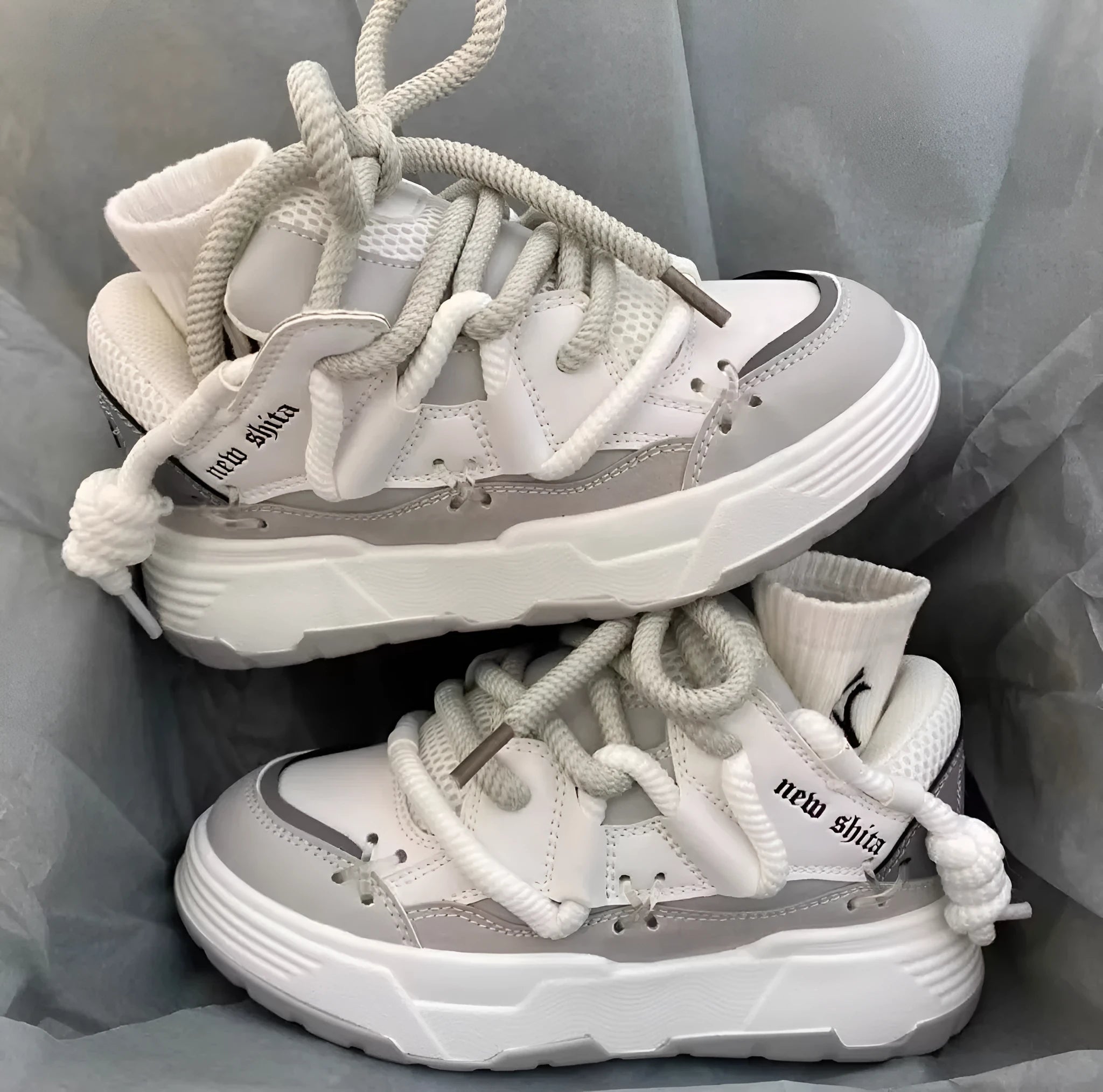 Women's grey retro chunky high-top sneakers with thick rubber platform sole and lace-up front.