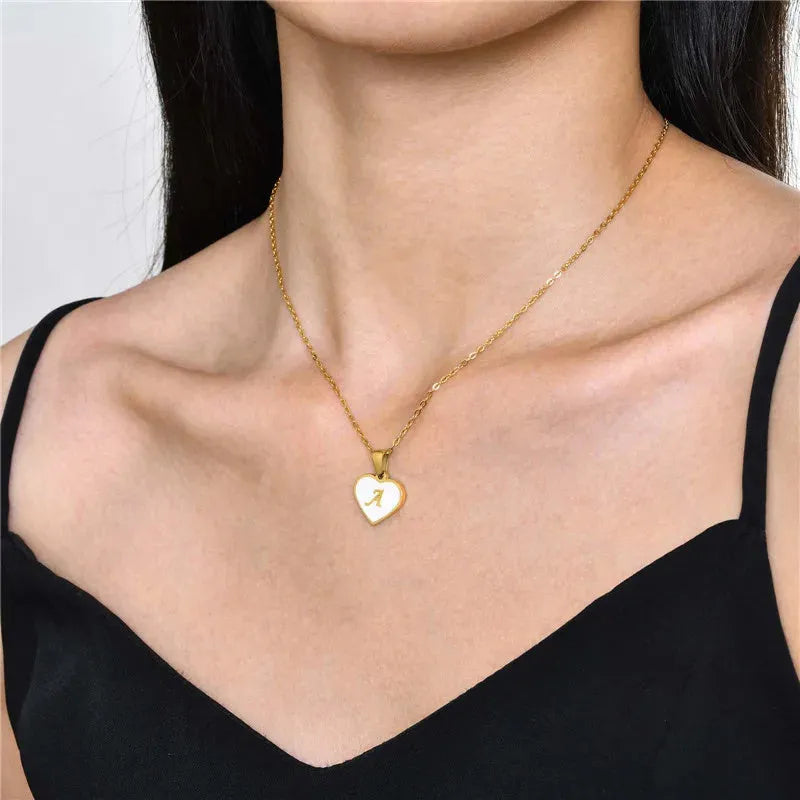 Gold plated heart-shaped personalised necklace with white shell charm on an adjustable chain.