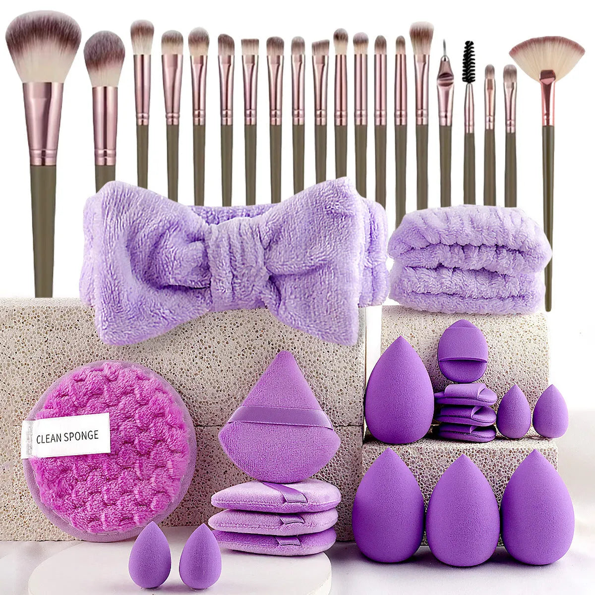 Beauty tool combination set with multiple pieces in pink, brown and purple colours for face wash and makeup application