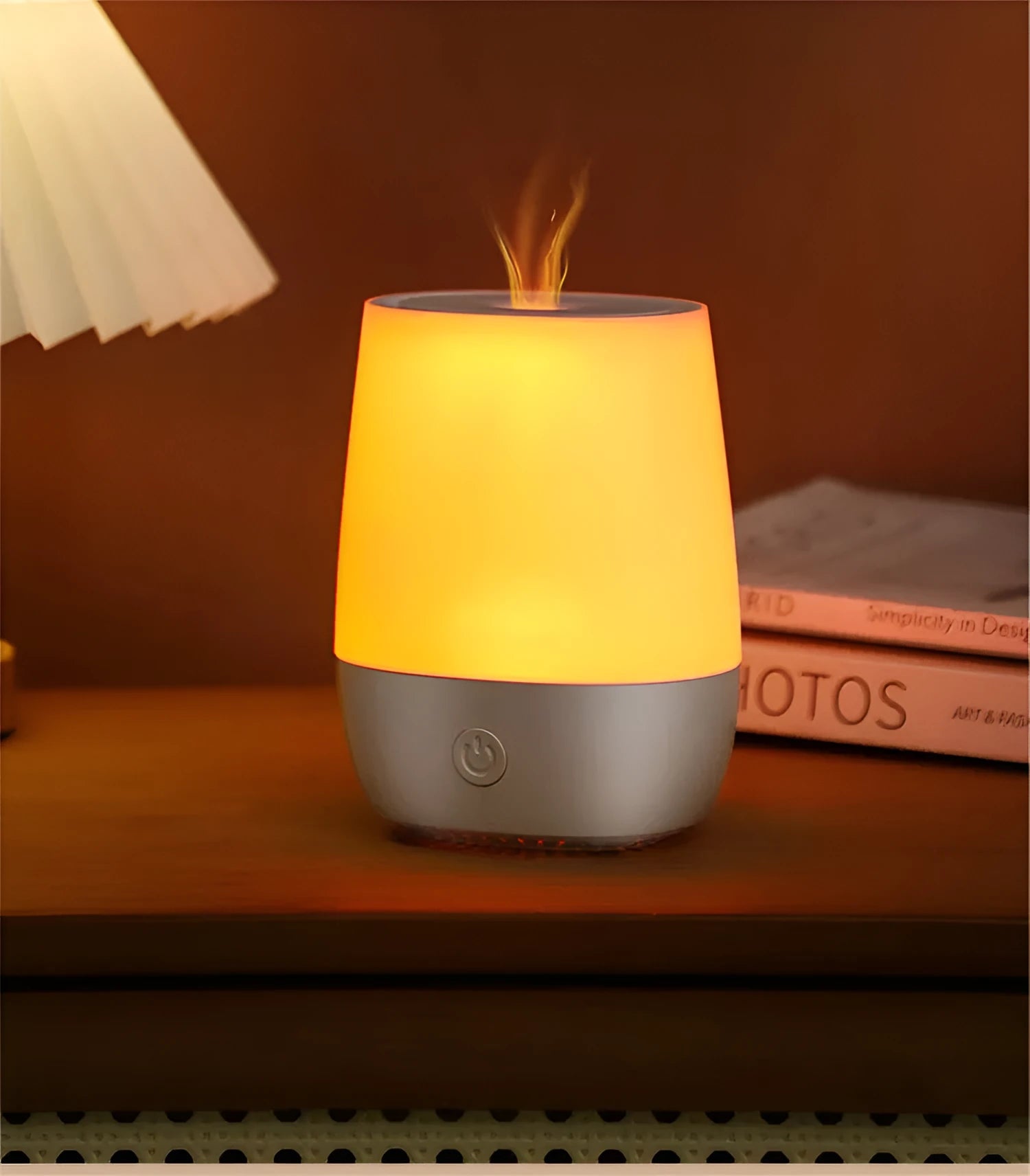 White USB aroma diffuser humidifier with flickering flame effect light on a wooden surface.