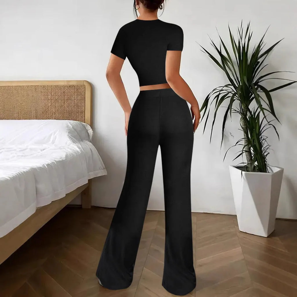 Women's black high waist trousers and short sleeve T-shirt suit set on a hanger