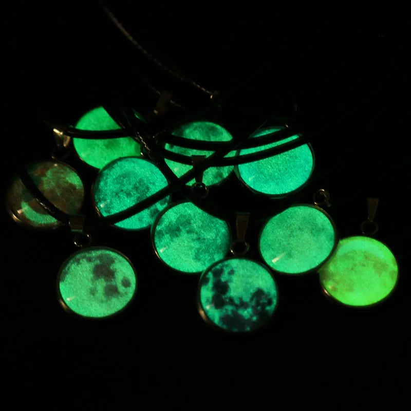 Luminous alloy and organic glass constellation pendant necklace with adjustable chain on white background.