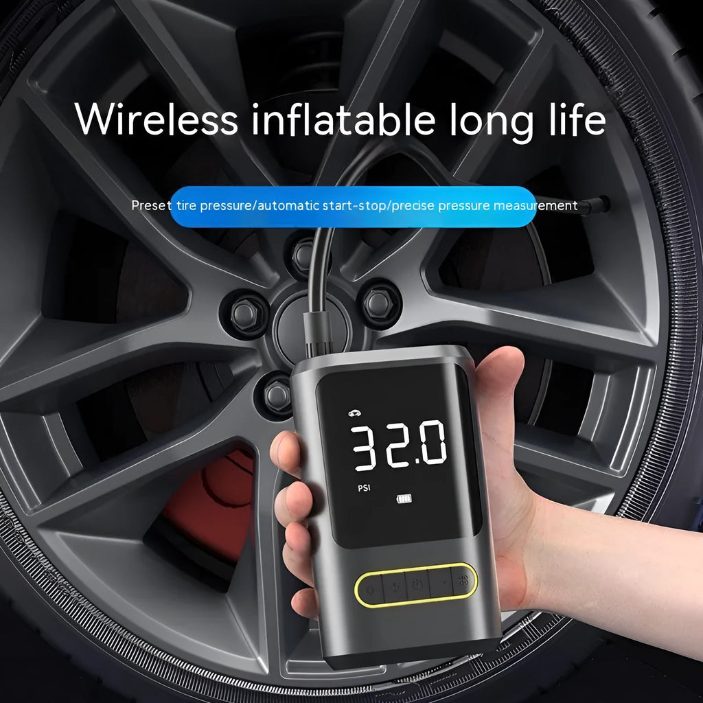 Black handheld digital wireless air pump with LED display and connected air hose on a grey background.