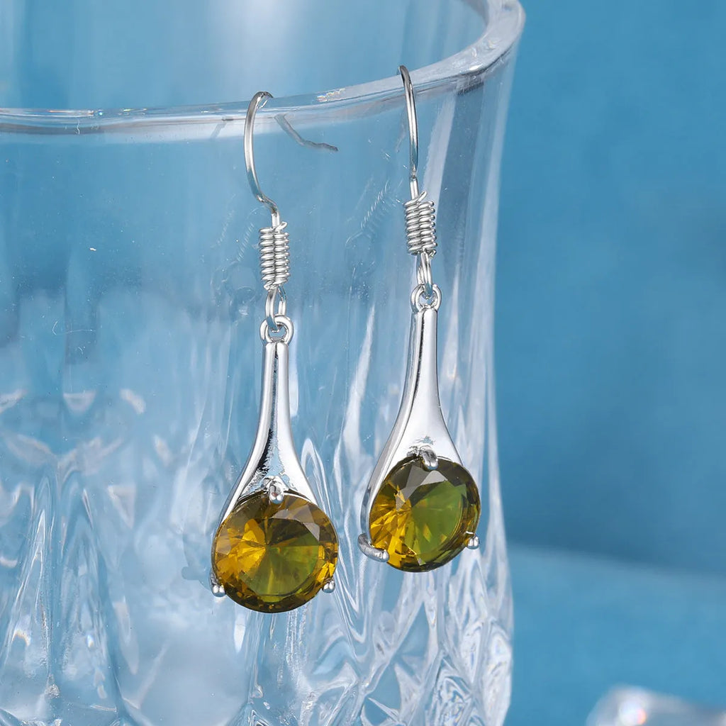 Olive green topaz coloured drop earrings with a water drop shape and minimalist retro design.