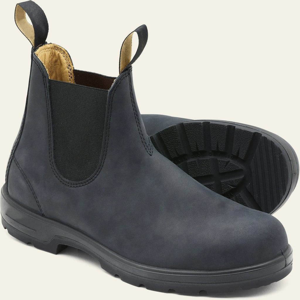 Vintage frosted brown leather Chelsea boot with round toe and low heel on a wooden surface.