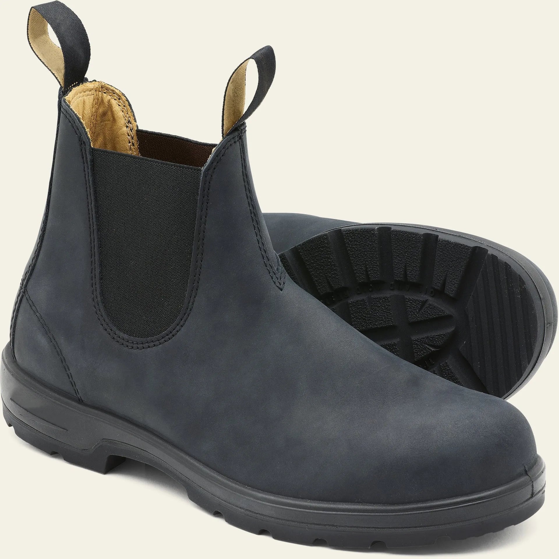 Vintage frosted brown leather Chelsea boot with round toe and low heel on a wooden surface.
