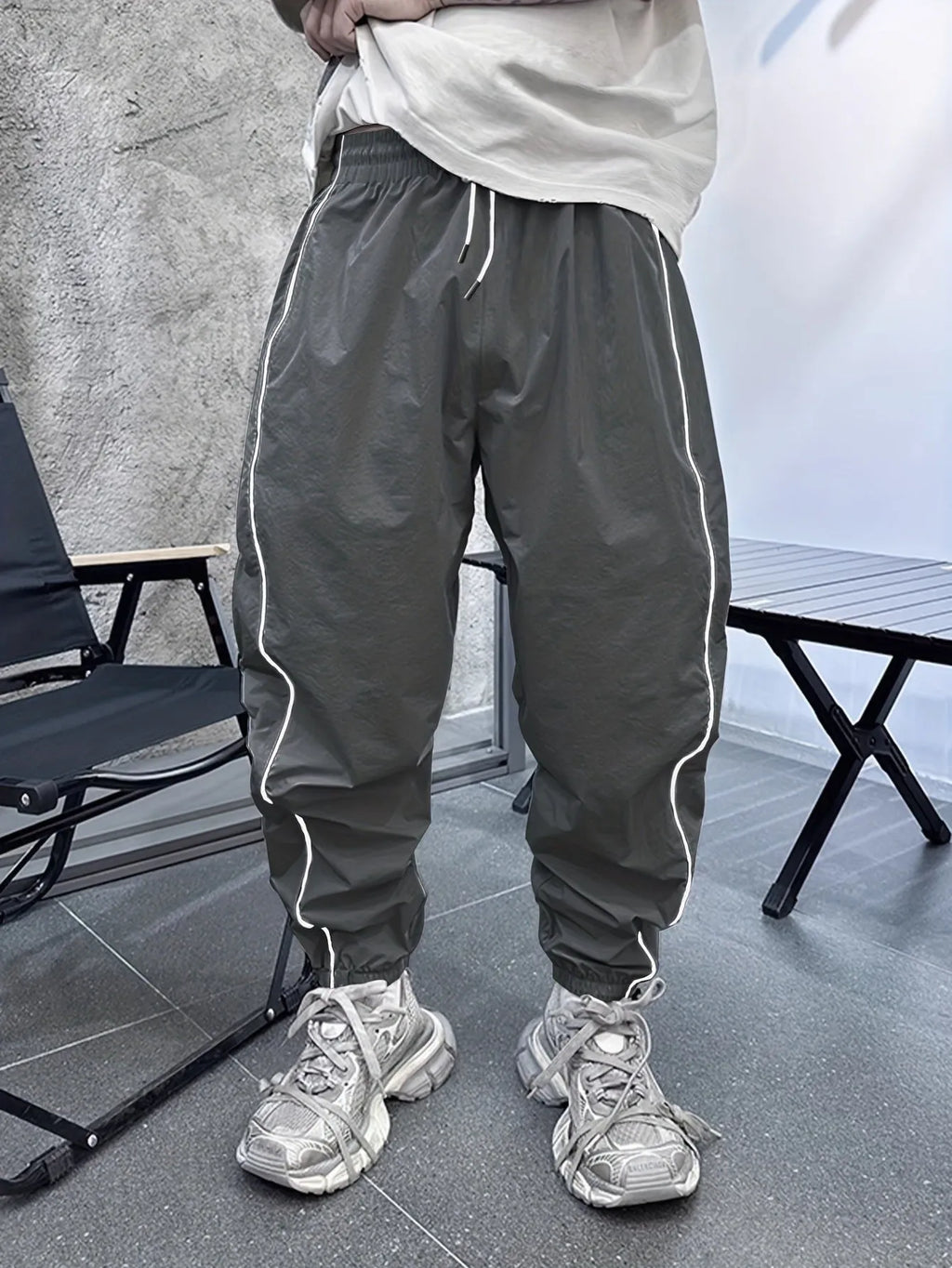 Men's blue bamboo fibre cropped sports trousers with a loose casual fit on a hanger.