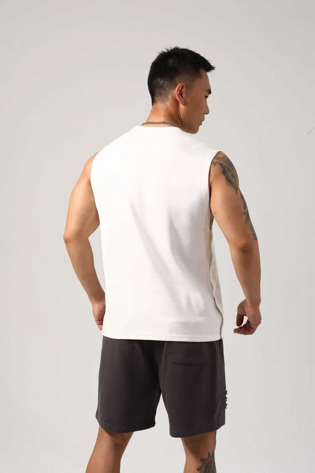 Men's black Korean style loose cotton fitness vest showing side hidden hook closure.