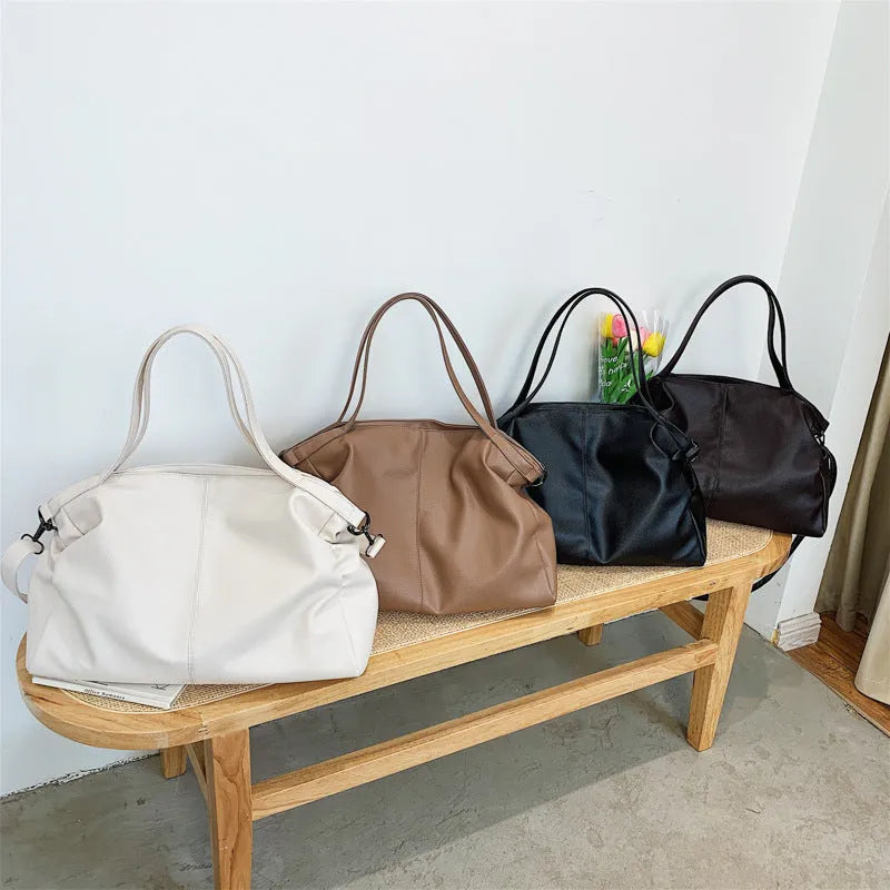 Soft surface messenger bag with adjustable strap showing mobile phone pocket and zipper compartments
