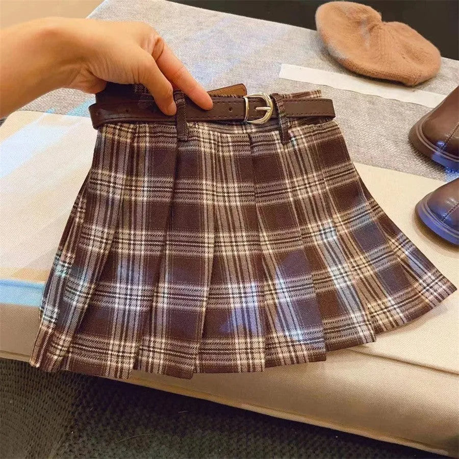 Girls plaid pattern pleated A-line skirt in cotton blend fabric on a hanger.