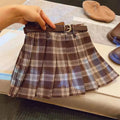 Girls plaid pattern pleated A-line skirt in cotton blend fabric on a hanger.