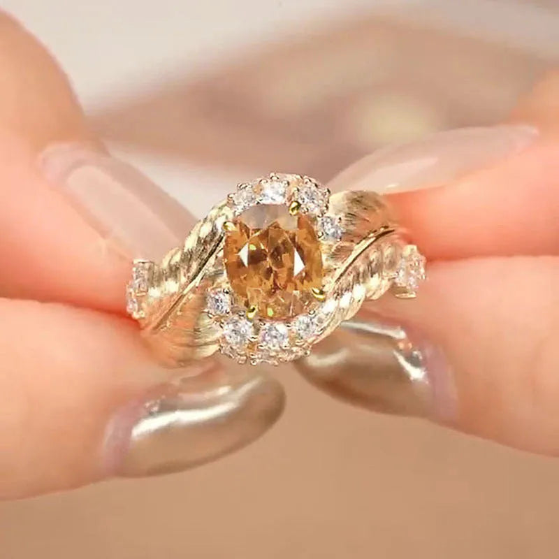 Gold colour copper ring with embossed feather design and inlaid yellow zircon stones.