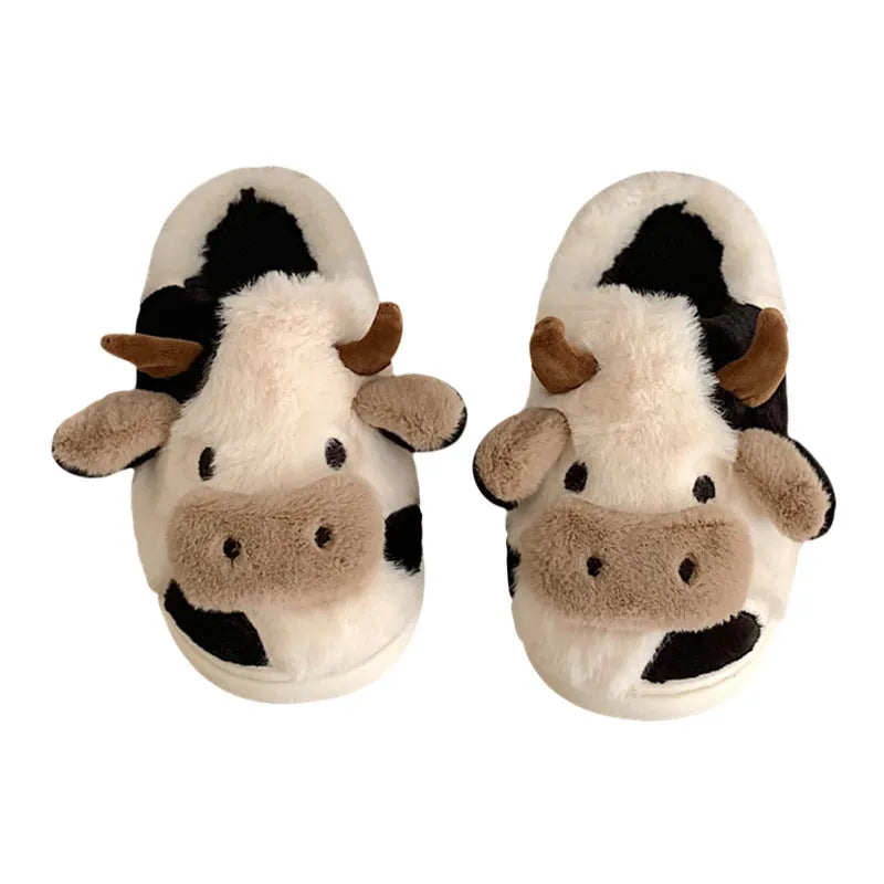White plush cow slippers for women with a non-slip textured sole.