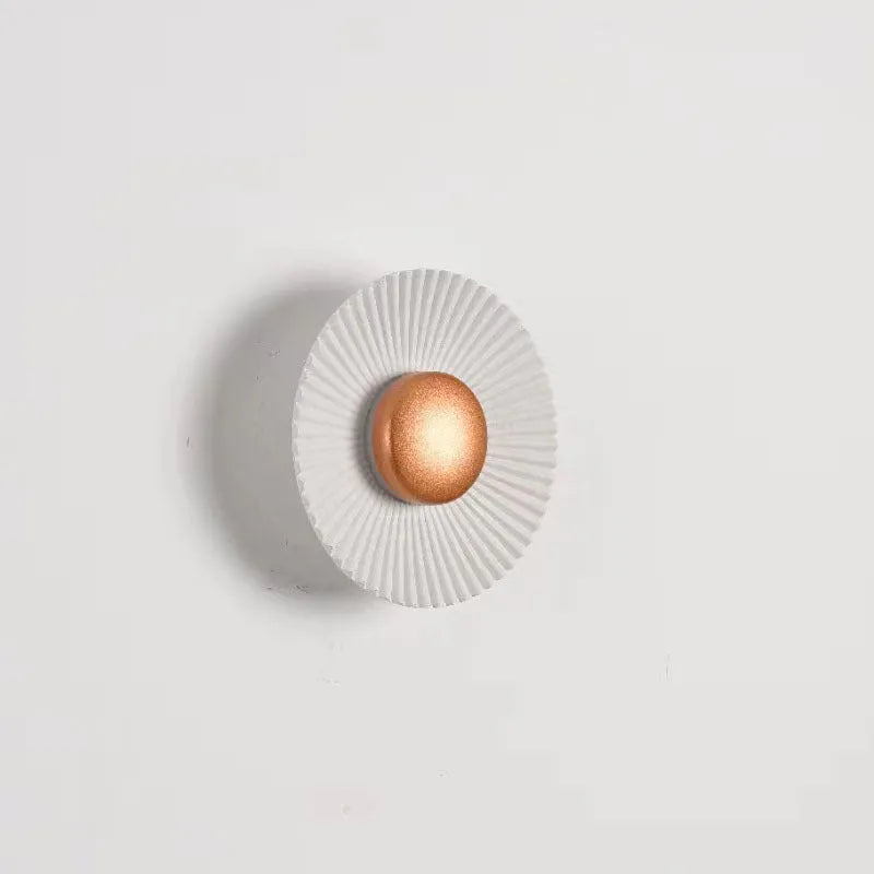 Round aluminium wall lamp with LED light in a choice of colour finishes including white and gold.