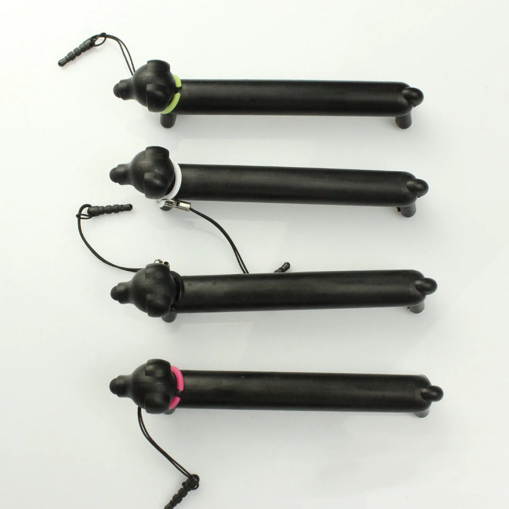Black dog-shaped touch screen stylus with conductive body shown next to smartphone demonstrating phone holder function