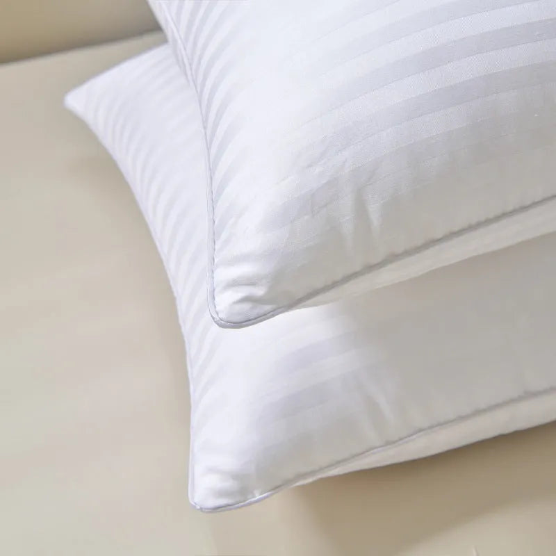 White hotel cotton satin stripe feather and cotton blend pillow showing satin stripe detail.